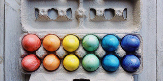 An egg carton with colorful Easter eggs